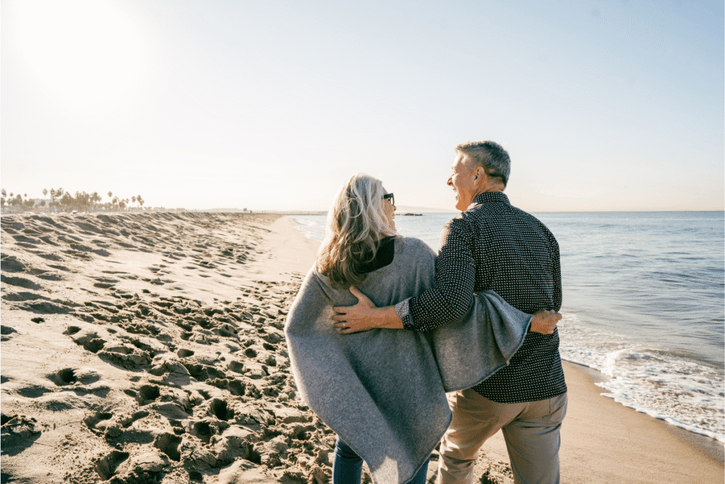 Retirement Planning in Tampa, FL 1 Retired couple walking on a Florida beach symbolizing financial security and peace of mind with insurance and risk management